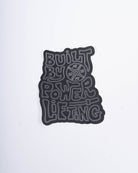 Front view of A7 Built By Sticker showcasing bold "Built By Powerlifting" text on matte polypropylene.