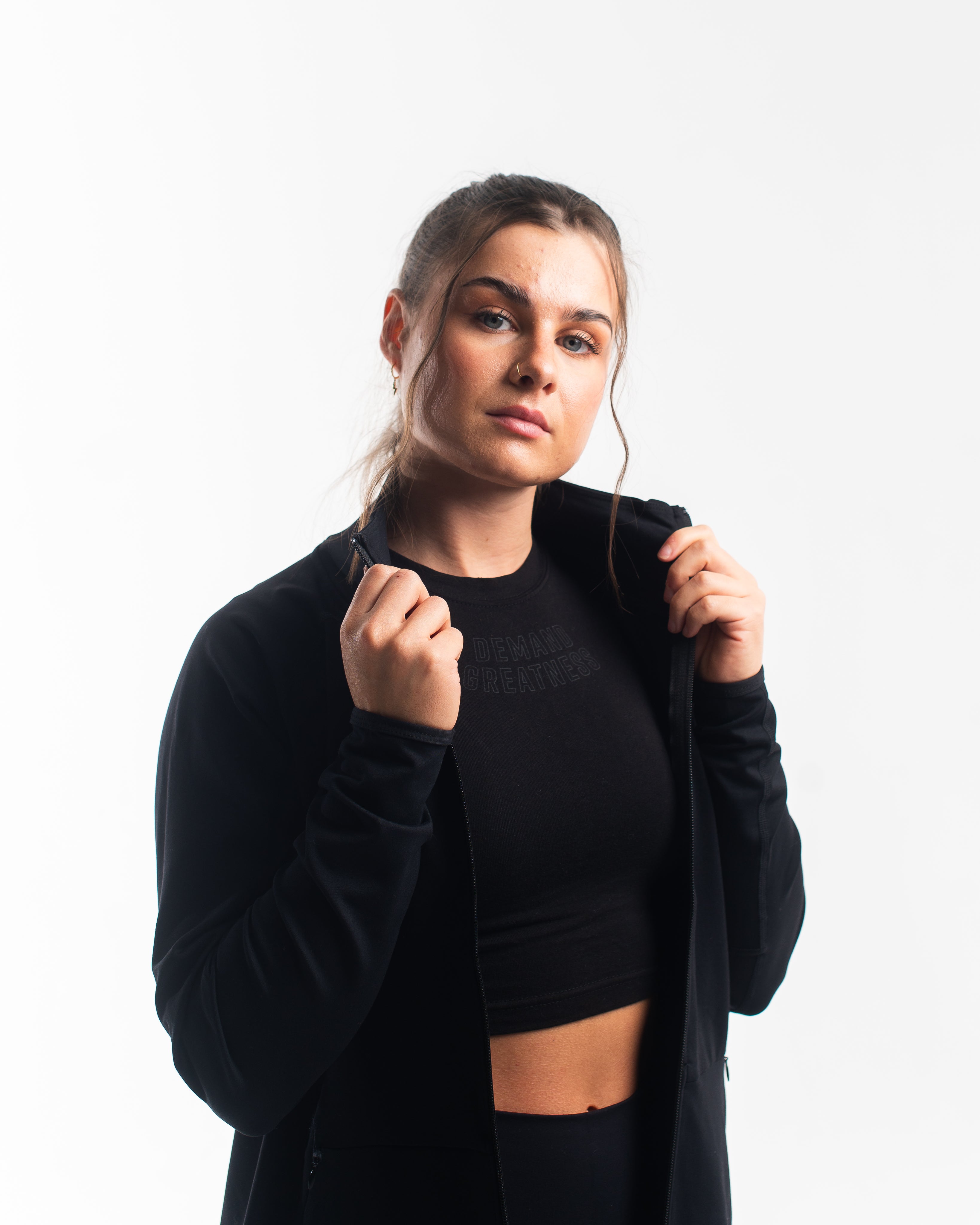 Front view of the A7 Defy Jacket – Stealth, showing clean unisex fit and front zipper design.