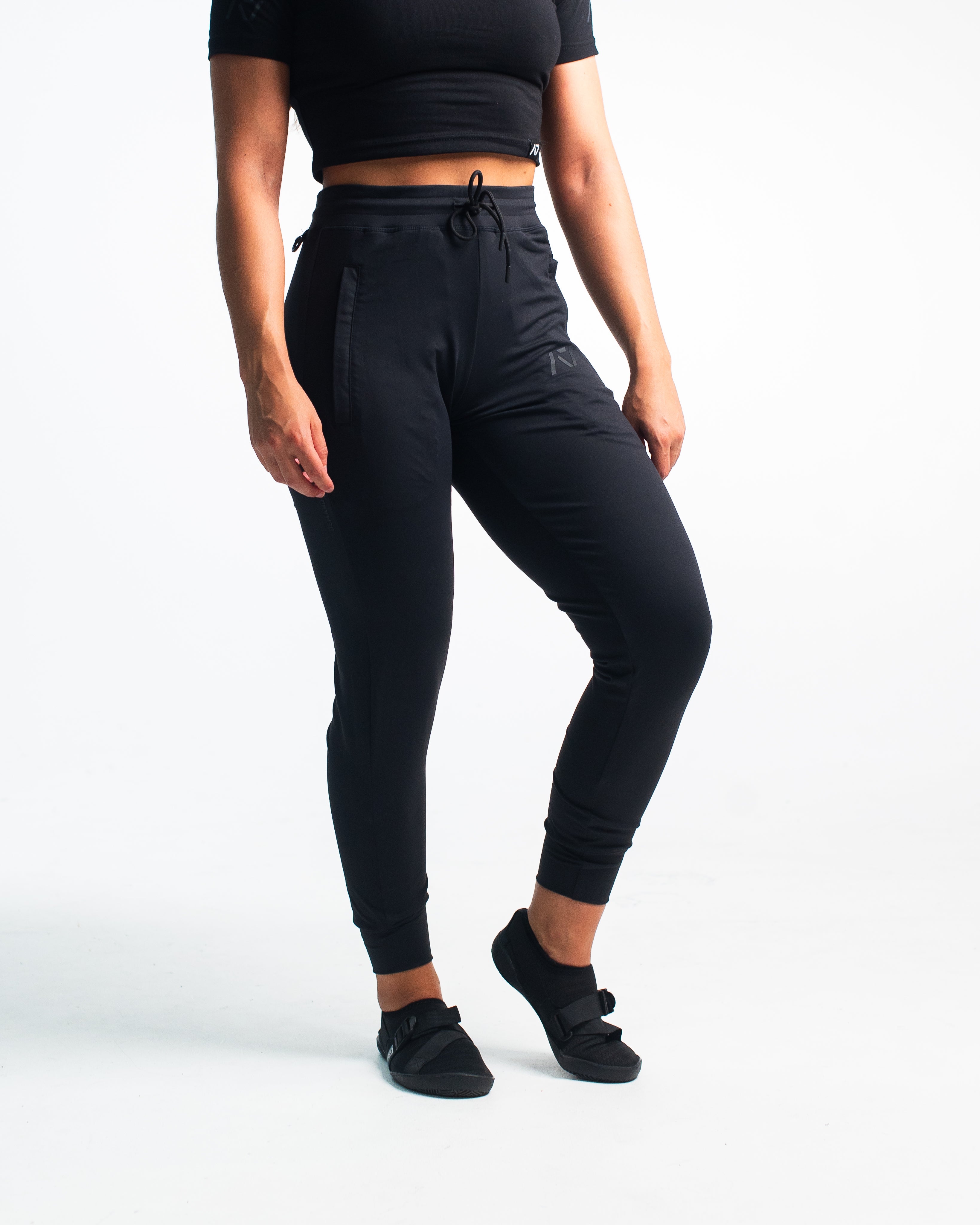 Front view of Stealth Defy Joggers showing tapered leg, mid-rise waist, and zippered front pockets.