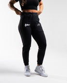Front view of the USAPL Classic Defy Joggers showing zippered pockets, mid-rise waist, and logos.
