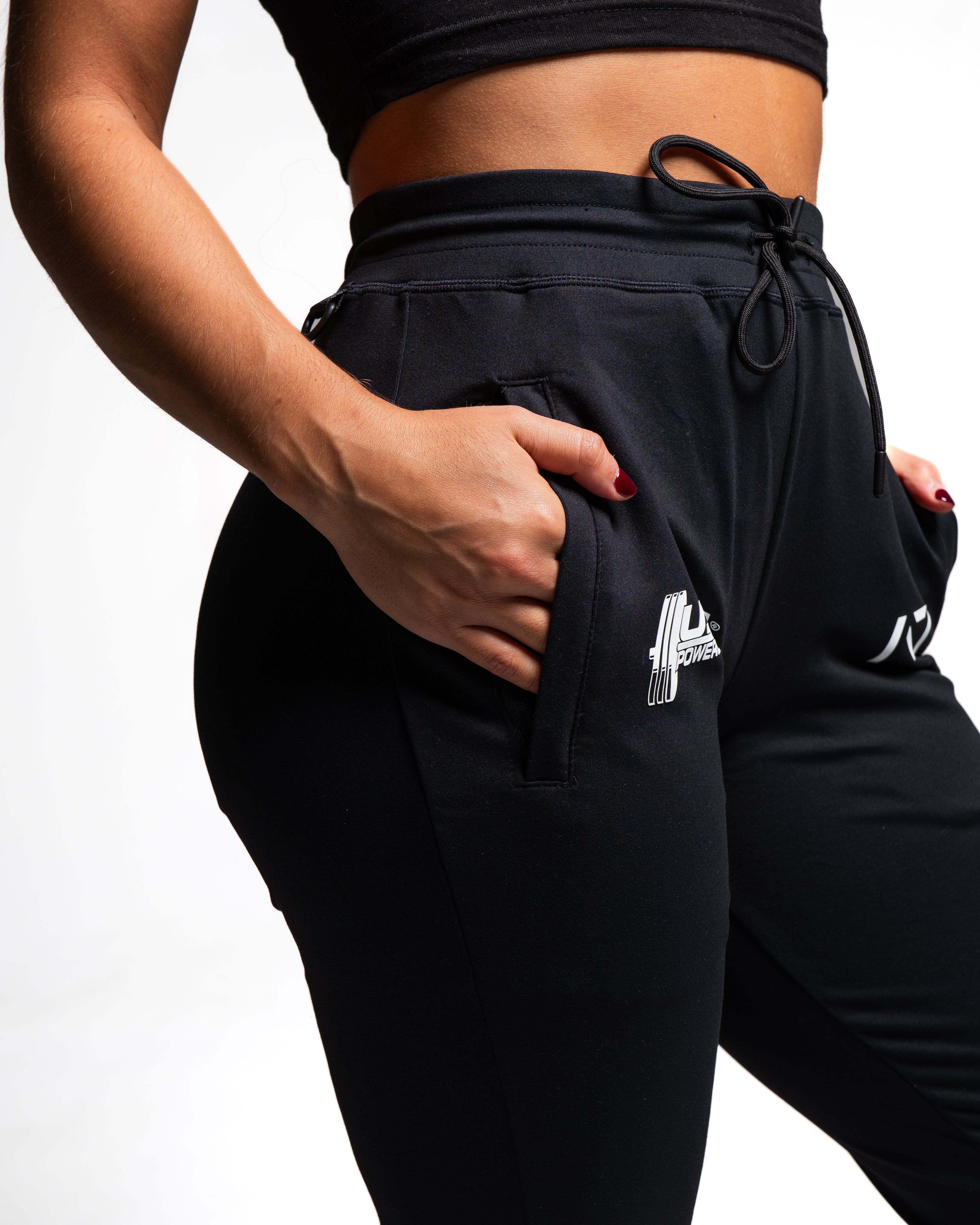 Close-up of front zippered pocket and moisture-wicking stretch fabric.