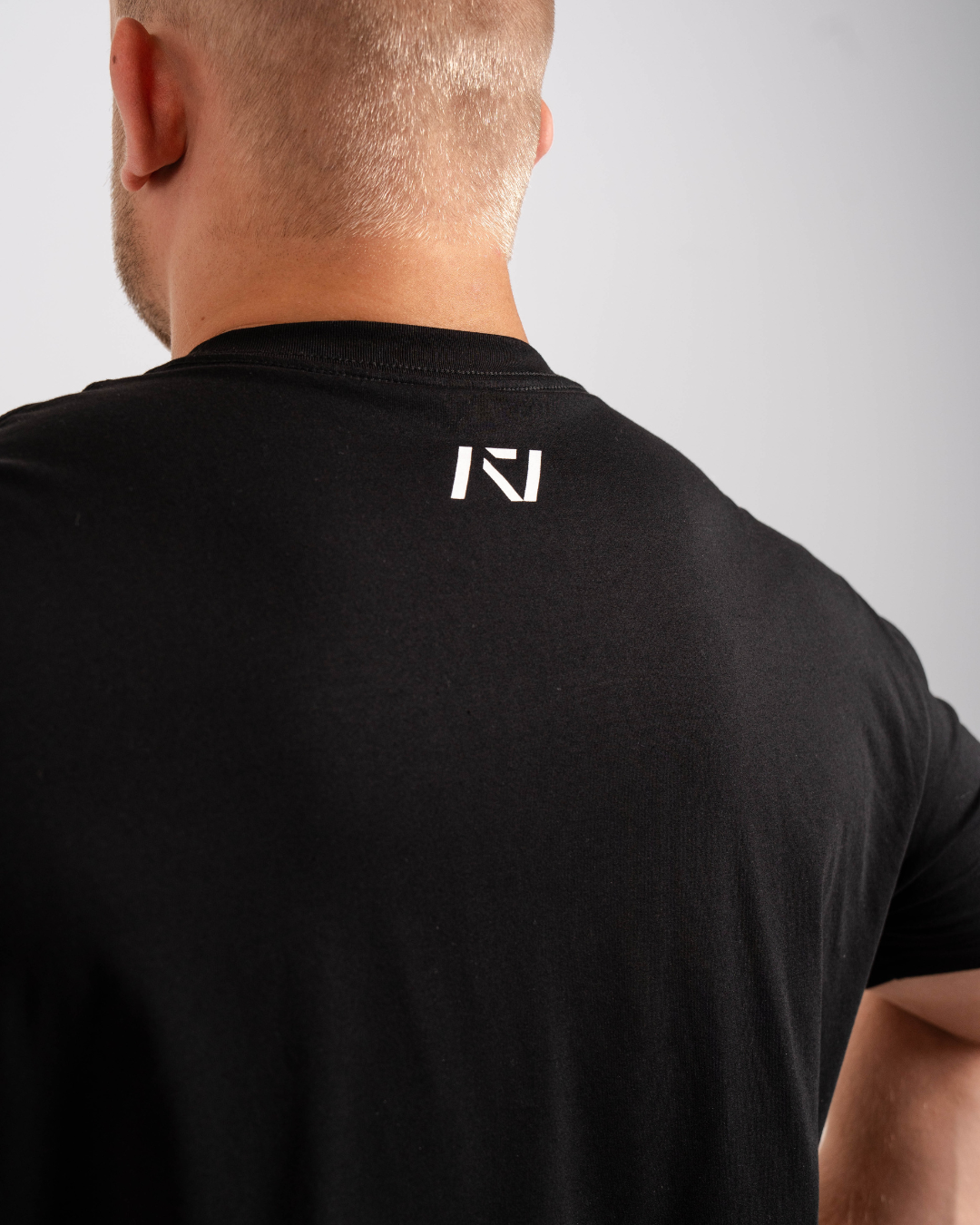 Back view highlighting A7 logo printed below the neckline on the Domino shirt.