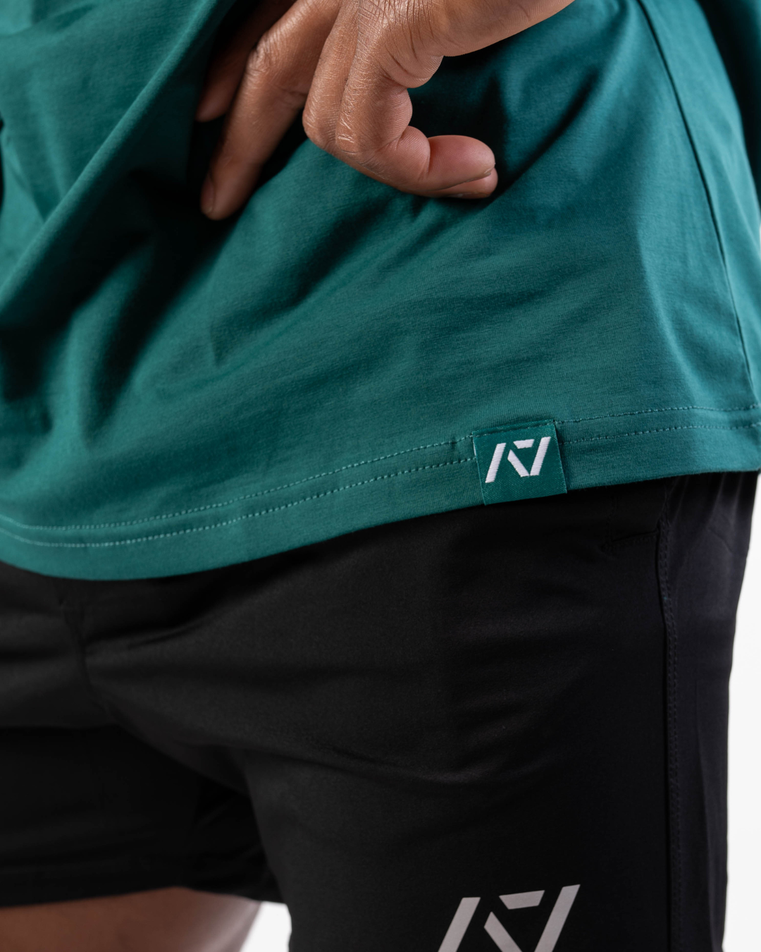 Close-up of woven A7 hem tag along the bottom hem of the shirt.