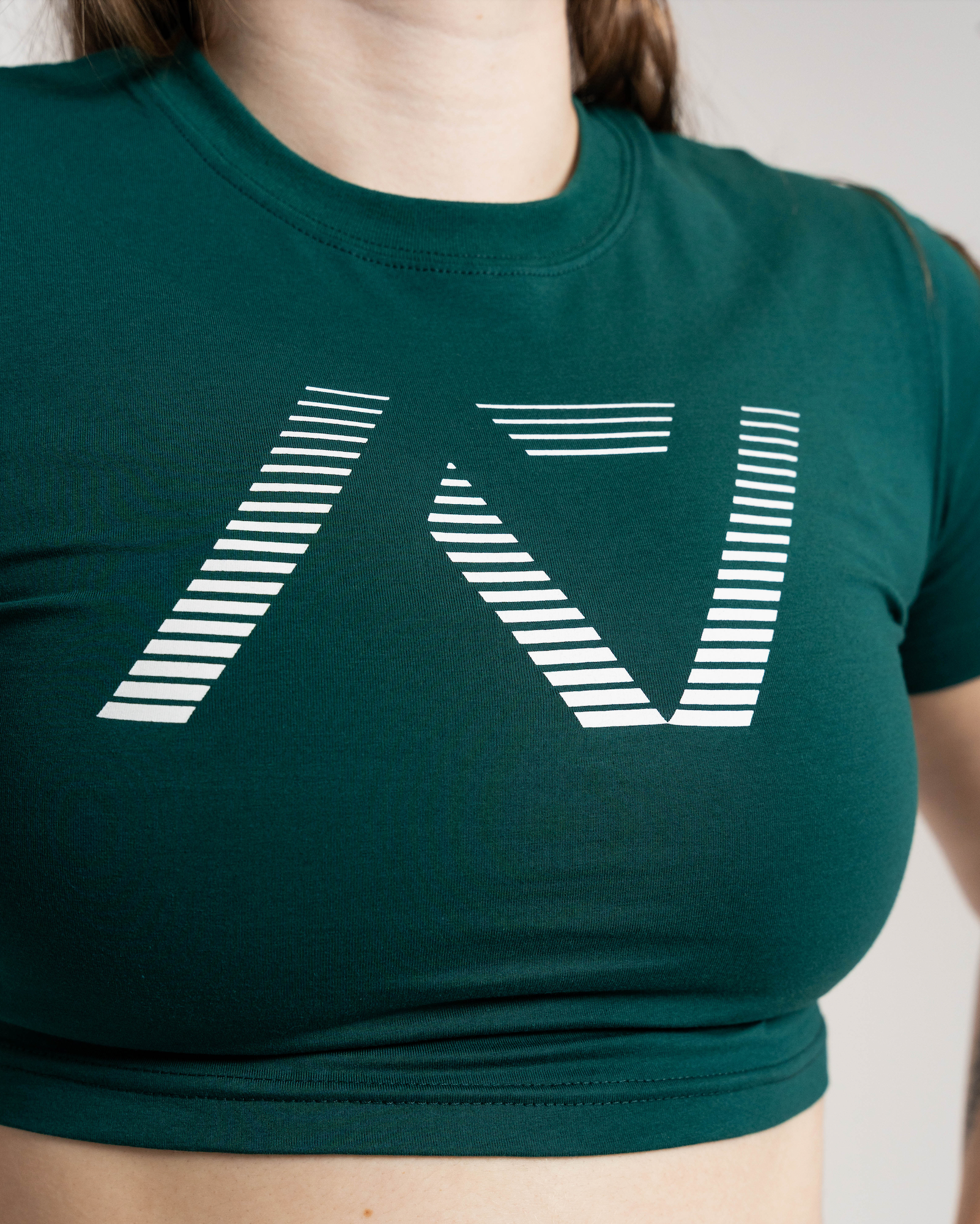 Green crop top with a white geometric design on a neutral background