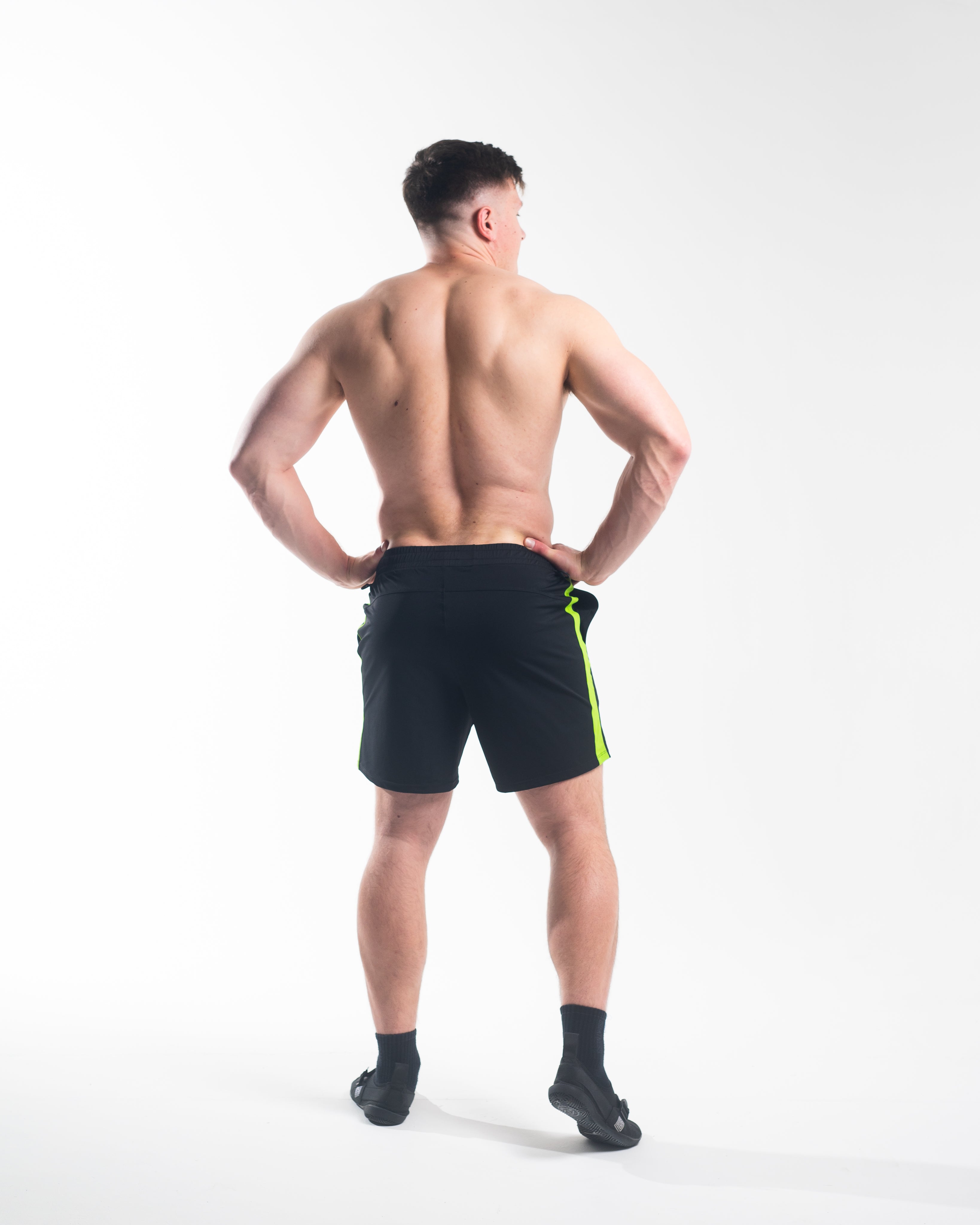 Rear view of A7 360Go KWD Shorts in Alien green with ripstop loop-through pockets and sleek performance silhouette.