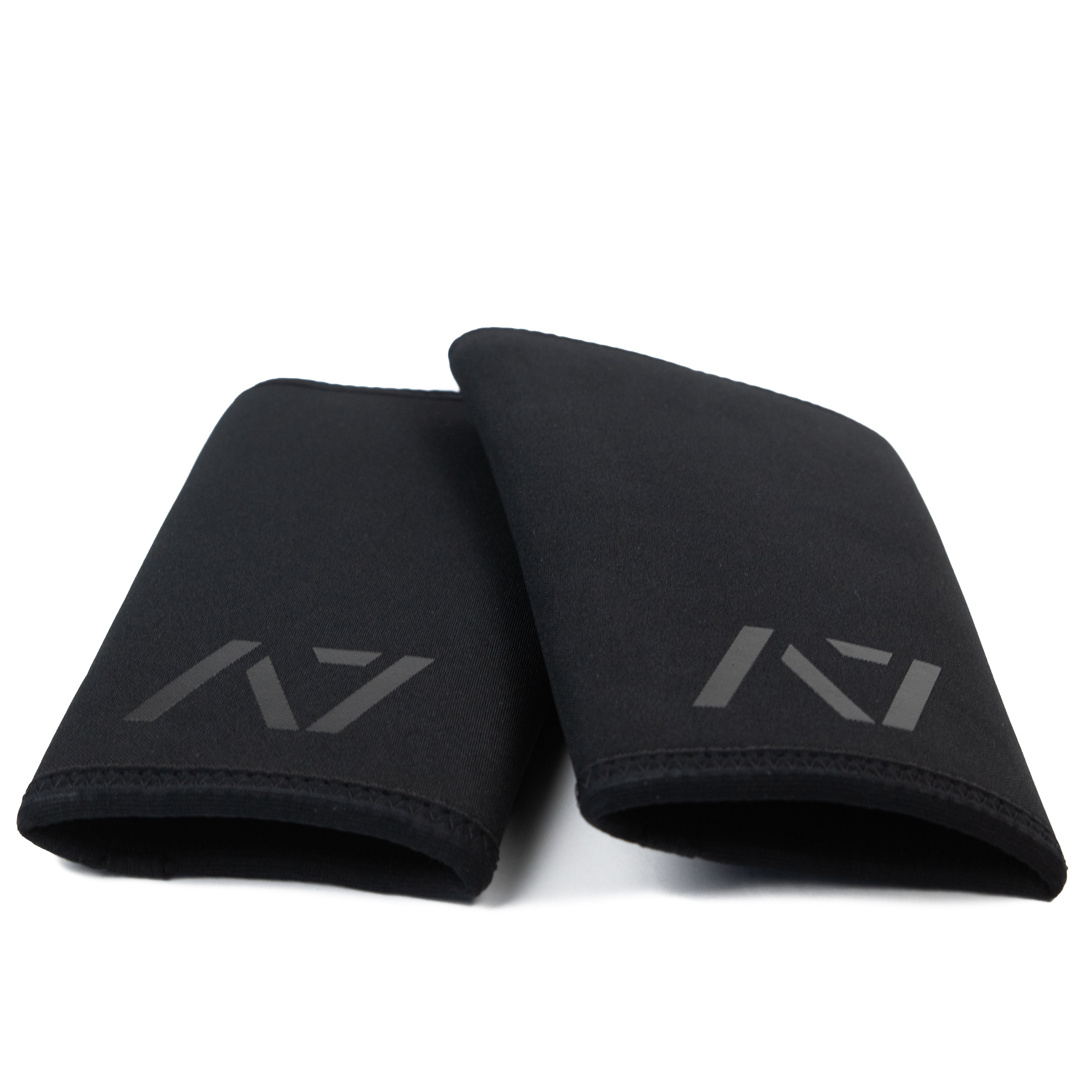 Flat lay of A7 Stealth Stiff CONE Knee Sleeves pair, illustrating unisex design and sleek black finish.