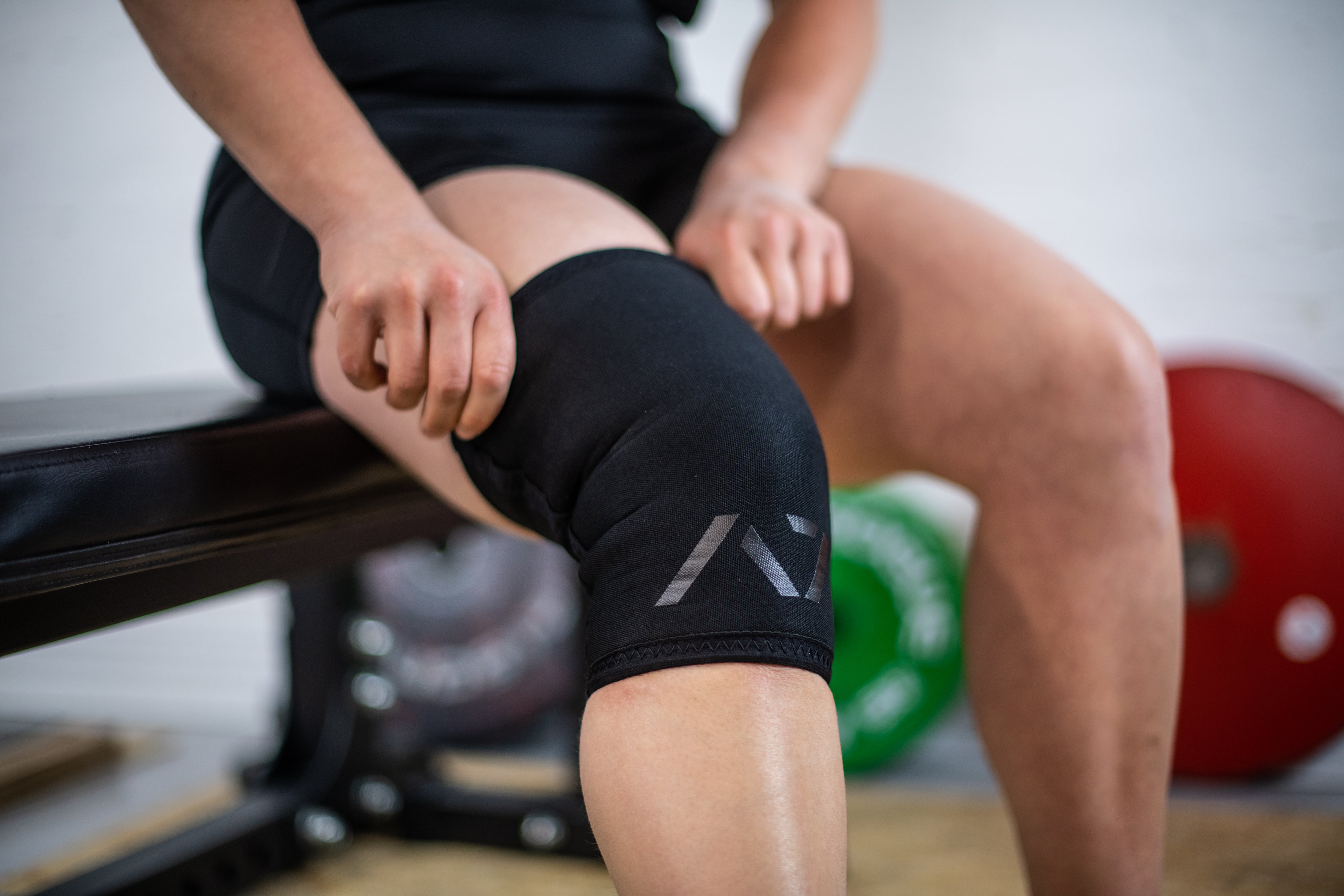 Athlete with A7 Stealth Stiff CONE Knee Sleeve on, displaying fit, A7 logo and double-stitched seams.
