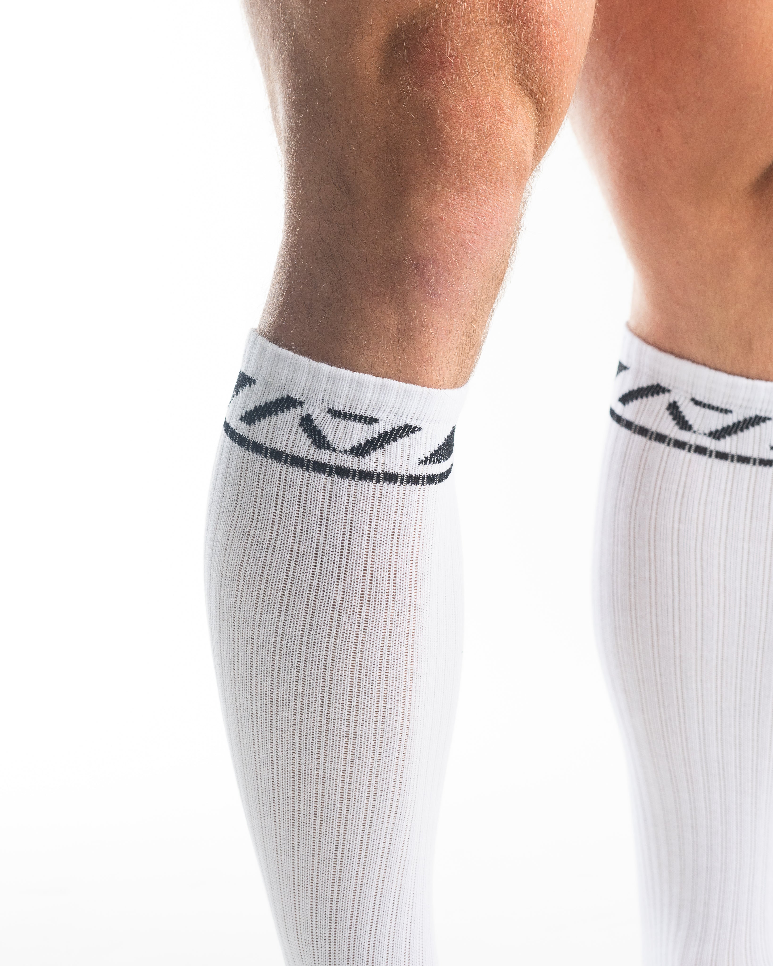 Close-up of the knit fabric on A7 Deadlift Socks in Domino White, showing texture and stitching details.