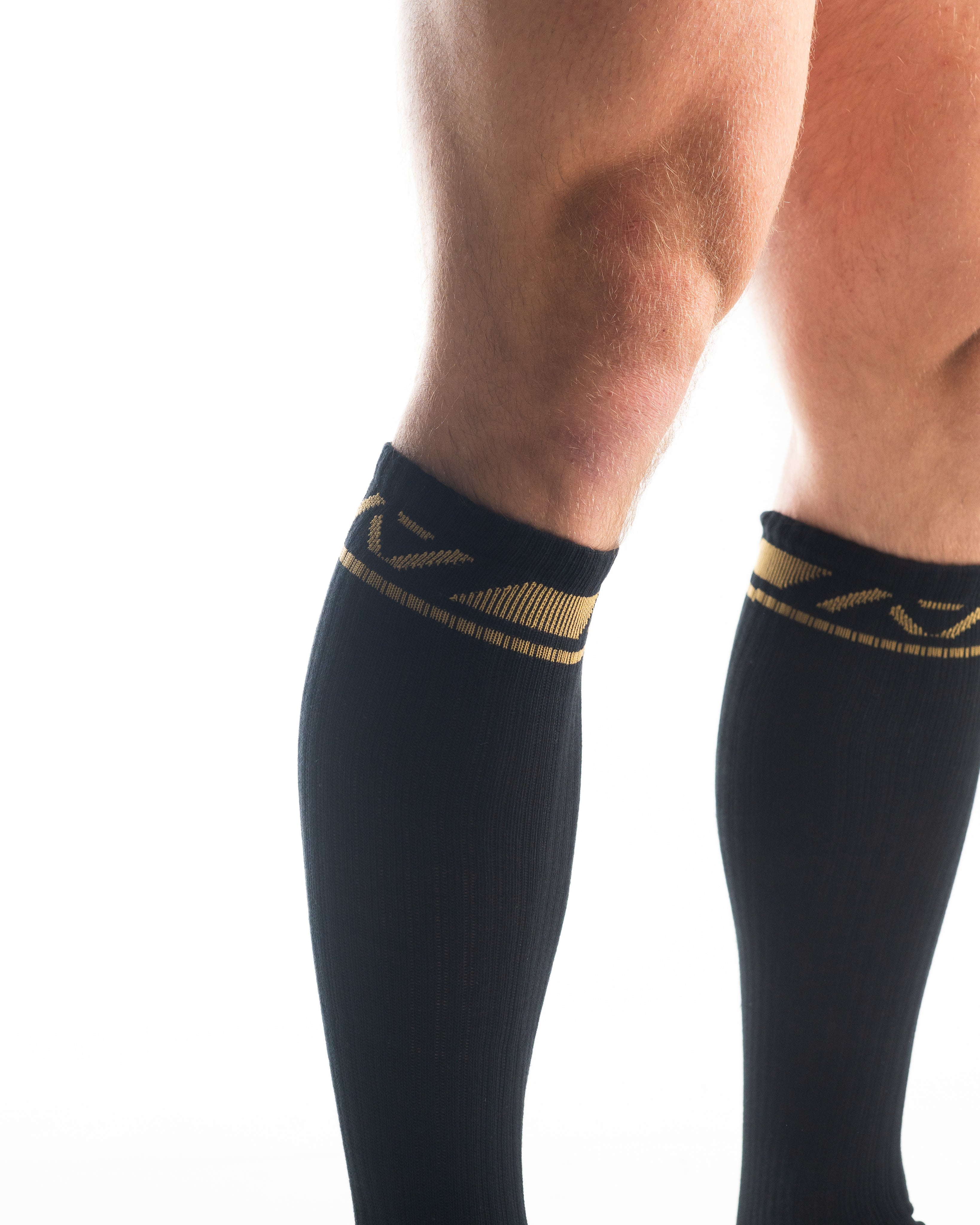 Close-up of the knit fabric on A7 Deadlift Socks in Gold Standard, showing texture and stitching details.